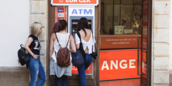 Three young women at ATM
